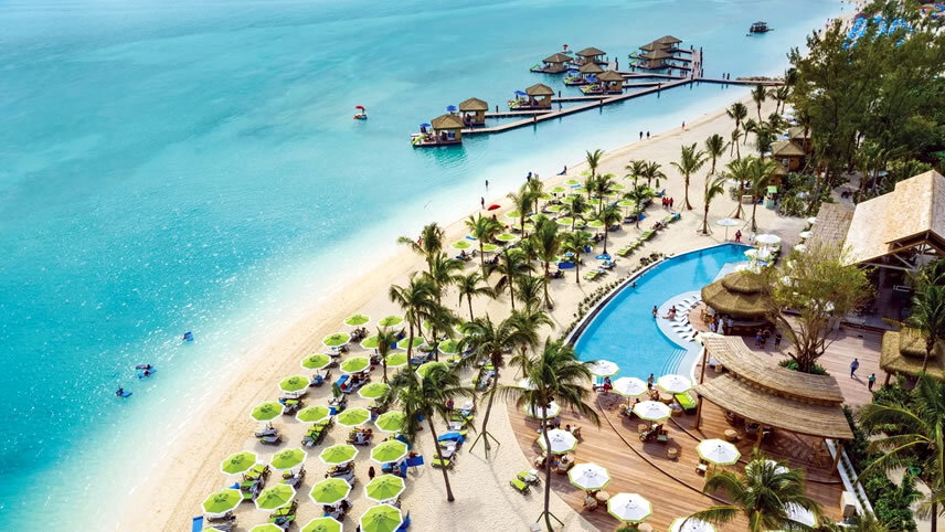 Tropical beach resort with turquoise water and pool